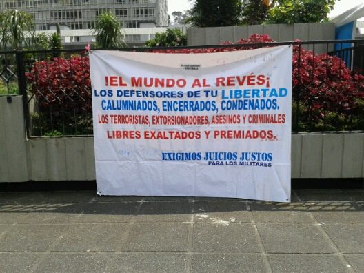 Pro-military sign outside the courtroom. "The world is upside-down! ...We demand fair trials for military officials."