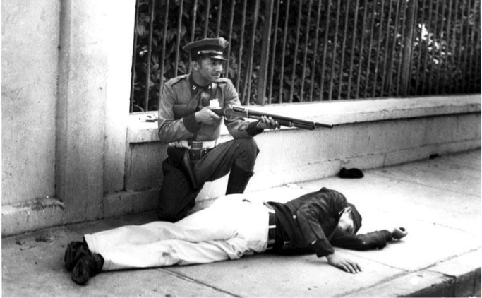 Officer Luis Anés Mariani takes cover behind a dead Cadet.
