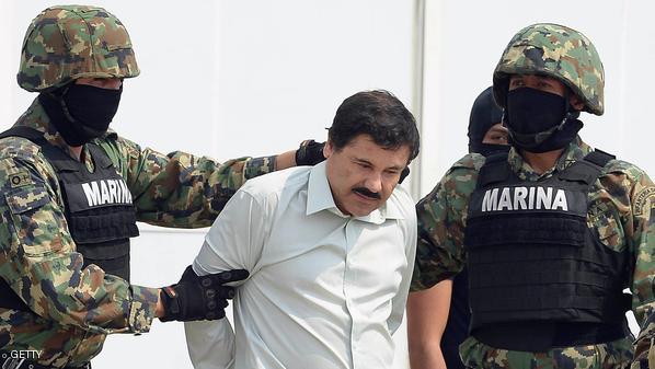 Mexican drug trafficker Joaquin Guzman Loera aka "el Chapo Guzman" (C), is escorted by marines as he is presented to the press on February 22, 2014 in Mexico City. (Alfredo Estrella /AFP/Getty Images)