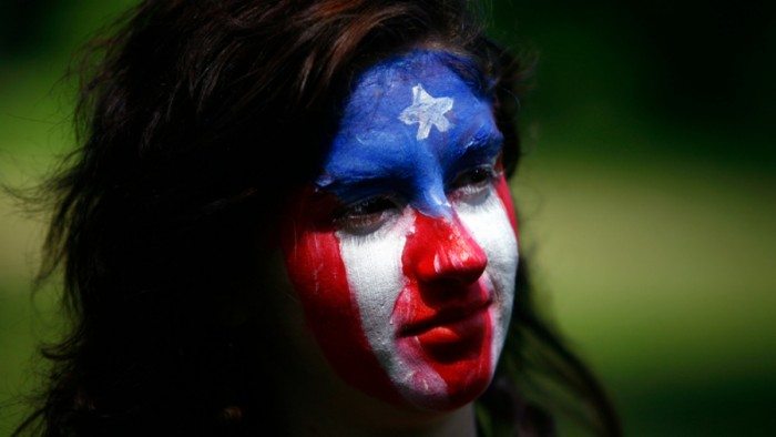 Puerto Rican flag-painted face at Occupy Puerto Rico protest in San Juan (Dave Lobby/Flickr)