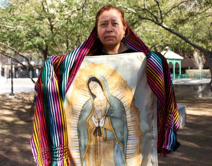 Sandra Torres, from San Antonio, holds an image of the Virgen de Guadalupe and a shawl made by women from Juárez. (Maria Equinca)