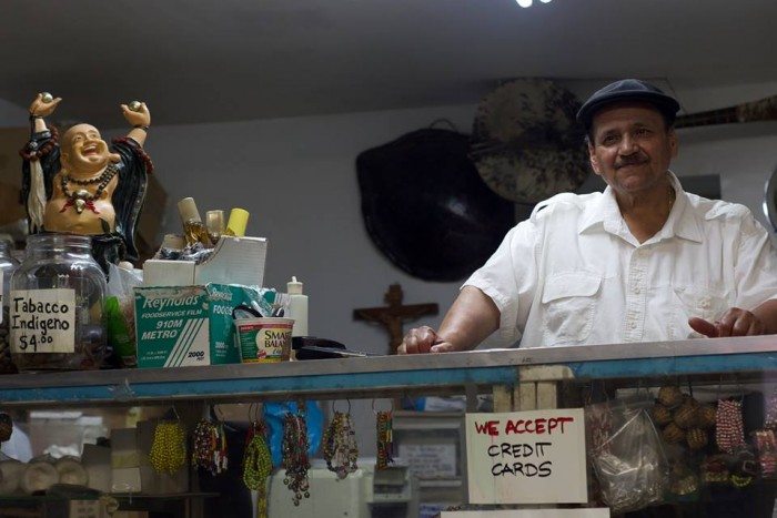 Jorge "Justo" Vargas behind the counter of his iconic botánica in Spanish Harlem (Photo Credit: Andrew J. Padilla) 