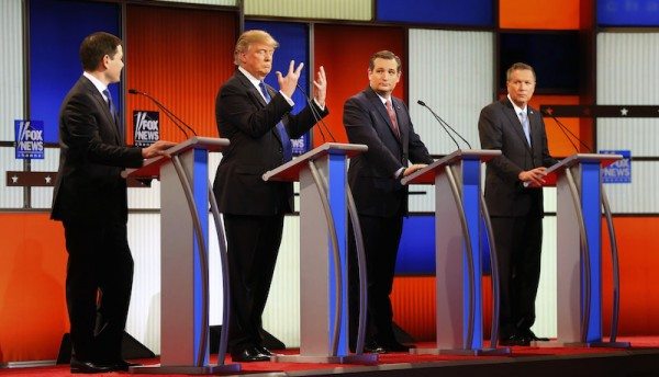 Republican presidential candidate, businessman Donald Trump, second from left, gestures as Sen. Marco Rubio, R-Fla., Sen. Ted Cruz, R-Texas, and Ohio Gov. John Kasich watch him a Republican presidential primary debate at Fox Theatre, Thursday, March 3, 2016, in Detroit. (AP Photo/Paul Sancya)
