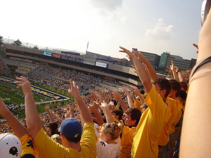 Students cheering at West Virginia University football game (Photo by Swimmerguy269)